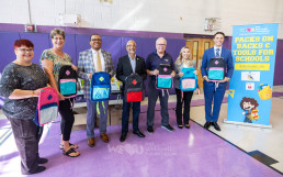 Donation of backpacks and school supplies to 12 schools across the United States